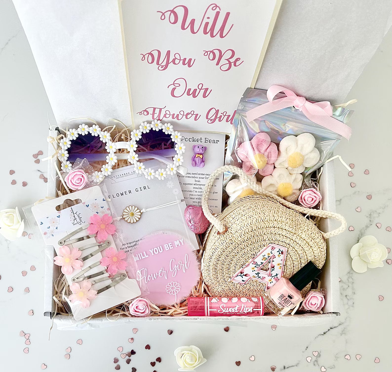 Gift box with 'Will You Be Our Flower Girl' items on a light background